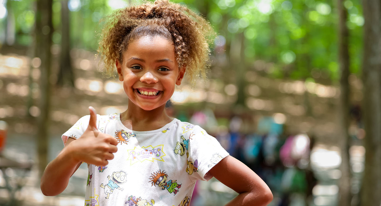 Girl giving a thumbs up