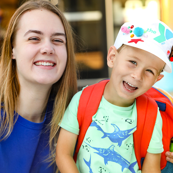 young boy with camp counselor