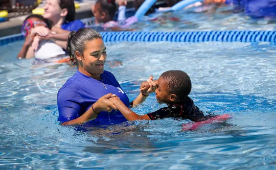 Young boy participating in swim lessons