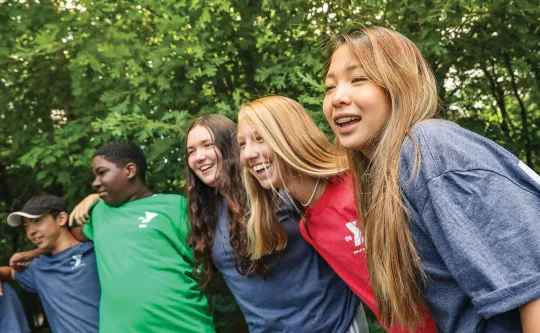 group of teens laughing together