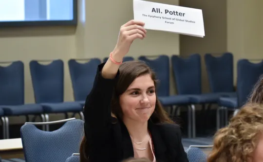 Student holding a placard