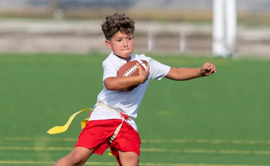 Boy playing flag football