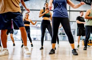 Group of people practicing line dancing