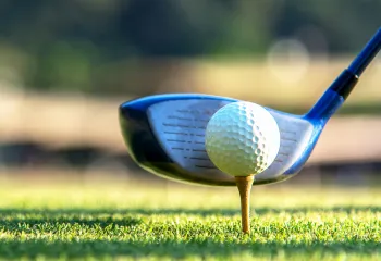 Golf club lined up with the ball