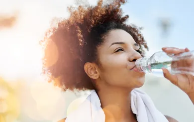 Woman drinking water after outdoor exercise