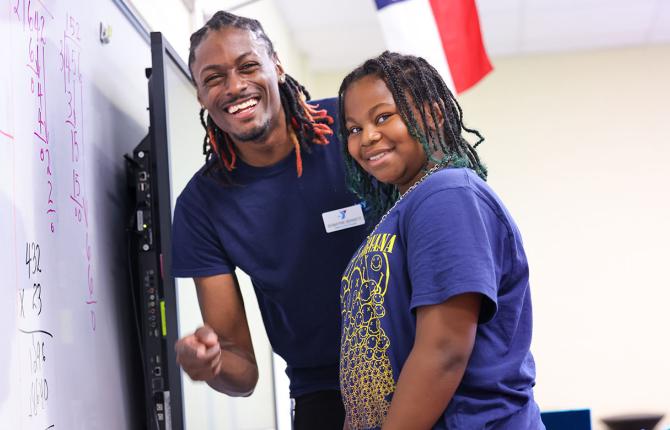 Teacher helping a child with math skills