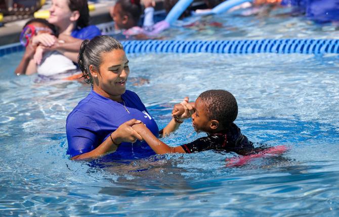 Young boy participating in swim lessons
