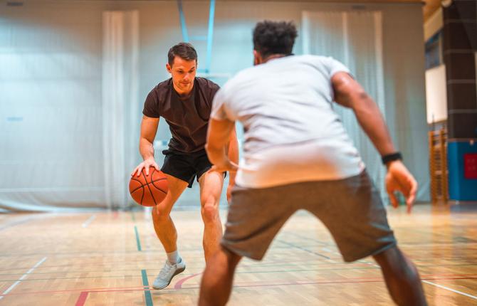 Two men playing pickup basketball