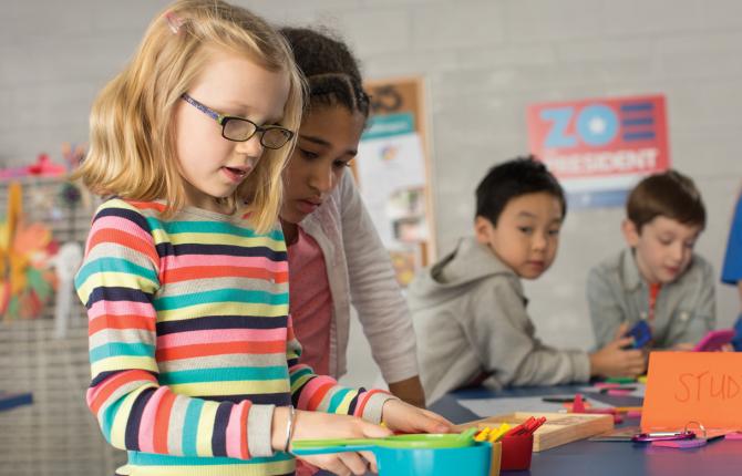 kids working on an experiment at a table